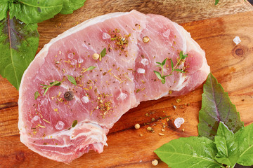 Raw pork meat with spices and herbs