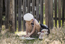 Boy Reads A Book In A Village On The Nature