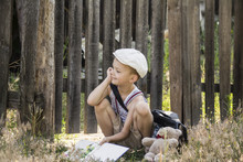 Boy Reads A Book In A Village On The Nature