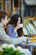 © Ekaterina Pokrovsky - Couple drinking coffee and eating croissants in Parisian cafe