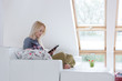 © Myvisuals - Young woman at home sitting on modern chair in front of window r