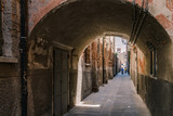 Fototapeta Na drzwi - Arched street in the town of Chioggia, Italy