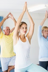 Instructor performing yoga with seniors