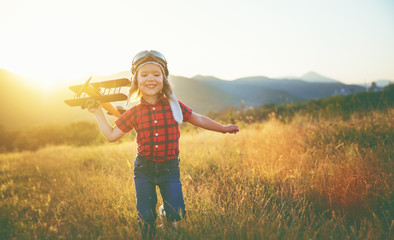 Wall Mural - happy child dreams of traveling and playing with an airplane pil