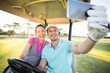 © WavebreakMediaMicro - Golfer couple taking selfie while sitting in golf buggy