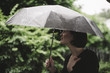© Westend61 - Woman with umbrella on a rainy day