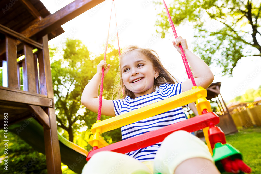 Portrait of happy little girl on a swing Stock Photo | Adobe Stock