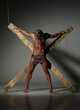 © kazanovskyiphoto - Sexual naked man, muscular, hands tied rope to wooden beams