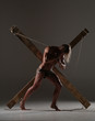 © kazanovskyiphoto - Sexual naked man, muscular, hands tied rope to wooden beams