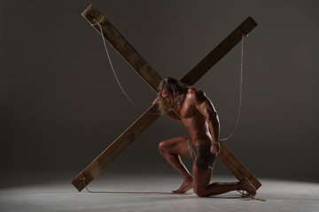 Wall Mural - Sexual naked man, muscular, hands tied rope to wooden beams