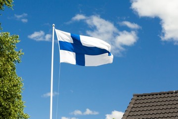 Wall Mural - Flag of Finland on sky background.
