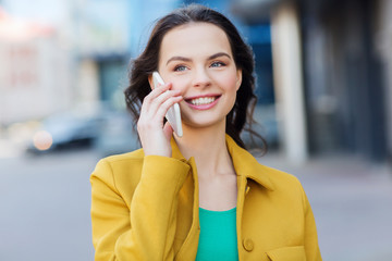 Wall Mural - smiling young woman or girl calling on smartphone