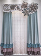 Soft velor curtains with colored frills, a light tulle and a stiff pelmet with lace applique on gangs.