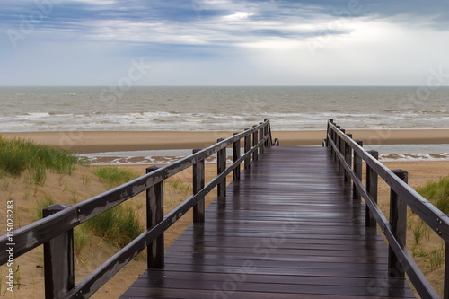 Naklejka - mata magnetyczna na lodówkę Wooden staircase leading into stormy sky and sea at De Haan, Belgium