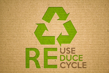 Recycle green symbol on cardboard with text recycle reuse reduce