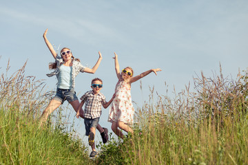 Wall Mural - Happy children playing on the field at the day time.