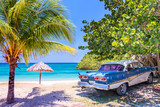 Fototapeta Łazienka - Vintage american oldtimer car parked on a beach in Cuba