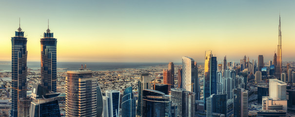 Wall Mural - Scenic panoramic view of Dubai modern architecture at sunset. Aerial skyline with downtown skyscrapers.