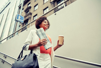 Canvas Print - happy african businesswoman with coffee in city