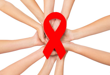 Canvas Print - close up of hands with aids and hiv awareness ribbon