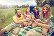 © Syda Productions - happy friends with tent and drinks at campsite