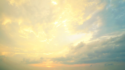 Wall Mural - a new heaven and earth concept: dramatic sun ray with yellow sky and clouds dawn texture background