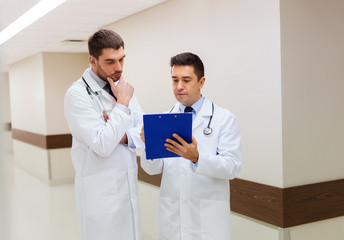 Wall Mural - two male doctors with clipboard at hospital