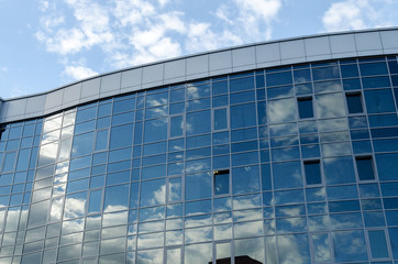 The architecture of the modern city. Business center. Reflection of the sky in windows of office building.