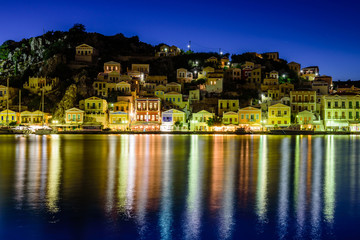 the scenic waterfront with colourful houses of Symi, night view, Symi island, Dodecanese, Greece.