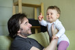 © scaliger - Happy baby plays with father at home