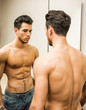 © theartofphoto - Young Man Admiring His Muscles in Mirror