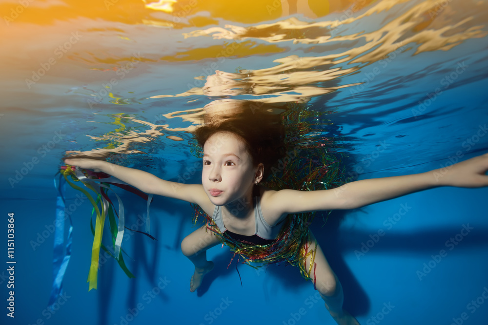 Little girl swimming and playing underwater in the pool. Portrait ...