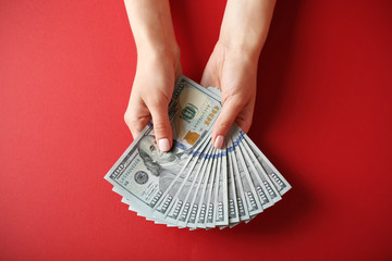 Sticker - Woman hands holding money on red background