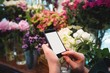 © Wavebreak Media - Hands of female florist holding mobile phone