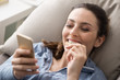 © StockPhotoPro - Woman on the couch using a smartphone