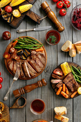 Wall Mural - Juicy steak cooked on a grill with grilled vegetables