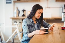 Woman Text On Phone While Holding Coffee 