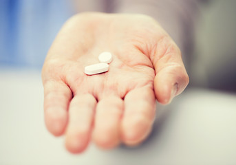 Canvas Print - close up of senior woman hand with pills