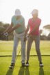 © WavebreakMediaMicro - Full length of mature male golf player teaching woman