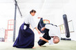 Mann und Frau kämpfen bei Aikido Training in Kampfsportschule 