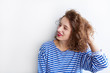 © kegfire - Portrait of a cheerful young woman with curly hair