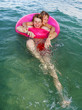 © travelview - brothers in a swim ring have fun in the ocean