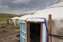 Gers At A Summer Nomad Camp Under Dark Skies With Nomadic Man Wearing Deel, Khujirt, Uvurkhangai (Ovorkhangai), Central Mongolia