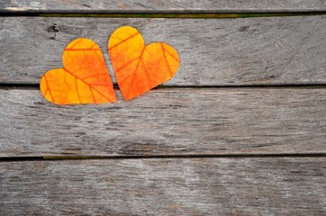 Wall Mural - Autumn leaves. Autumn leaves hearts on wood background.