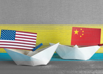 Wall Mural - paper ship with Flags of USA and China. conflict in South China Sea, concept shipment or free trade agreement and membership.