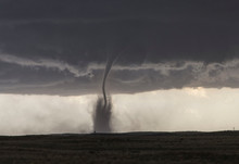  A Fine Tornado Dances Within A Cloud Of Dust That Moves In Ringlets Up The Lower Half Of The Tornado