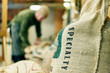 © Connect Images - Close up of speciality coffee bean sack in store room