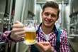 © WavebreakmediaMicro - Brewer holding a glass of pint beer
