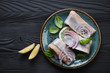 Top view of fresh herring fillet on a black wooden background