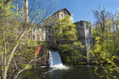 Fotografie, Obraz Historic, 19th century mill, known as Dart's Stone Mill, with water power sluice on the Hockanum River in Rockville, Connecticut